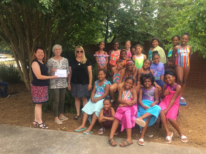 Sharing checks with YWCO Summer Girls Club members