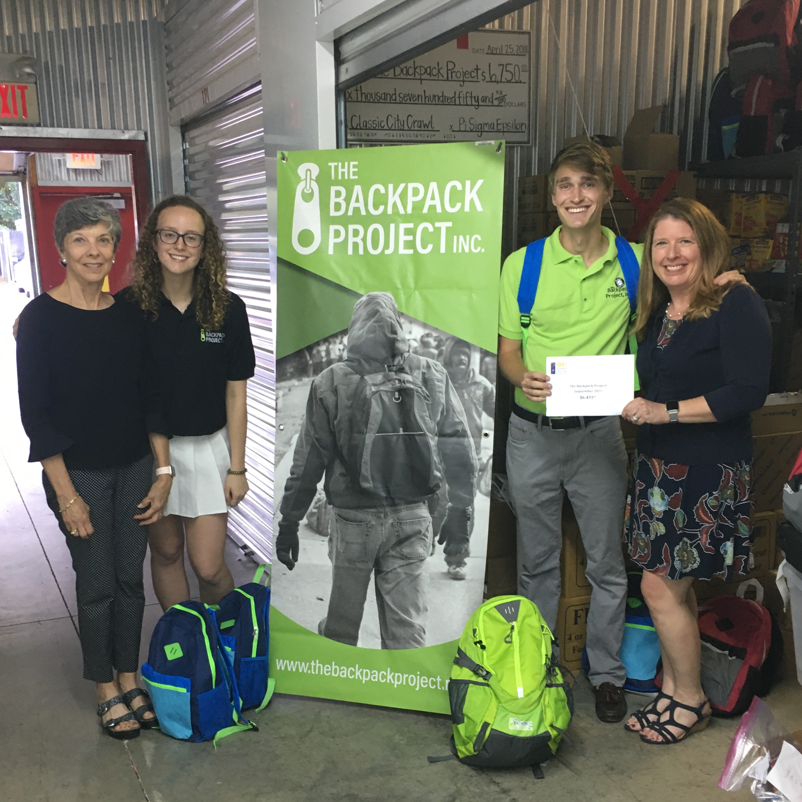 Sherry and Joan with Ashley and William at the Backpack Project warehouse